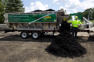 Landscape contractor using mulch hauling equipment for a landscaping project